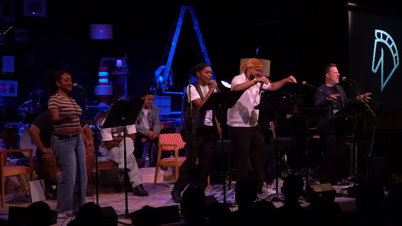 Musicians perform under dramatic stage lighting